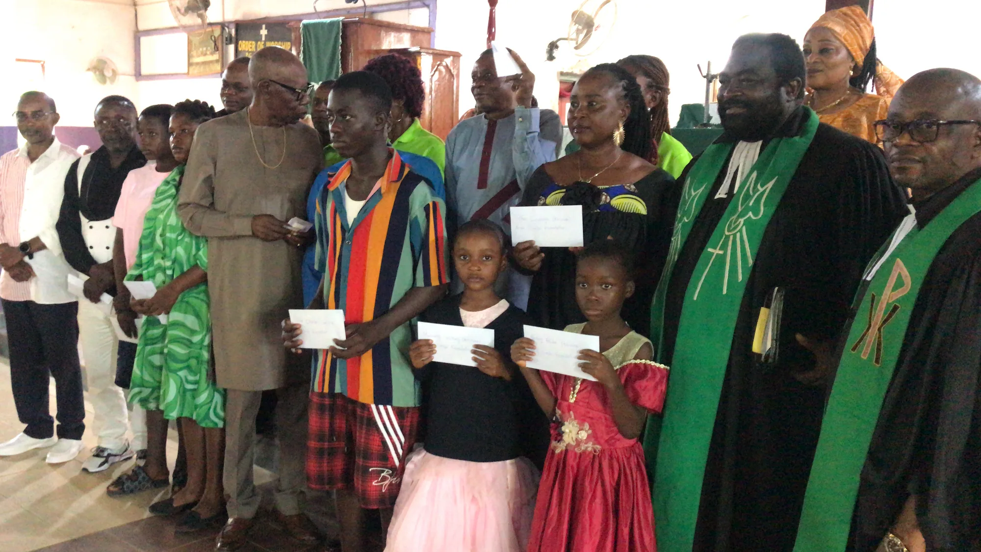 Prince Ndoki Mukete in a group picture with scholarship recepients and members  of the Smile Foundation, immediately after he handed the finacial package as support to the Back-to-school campaign